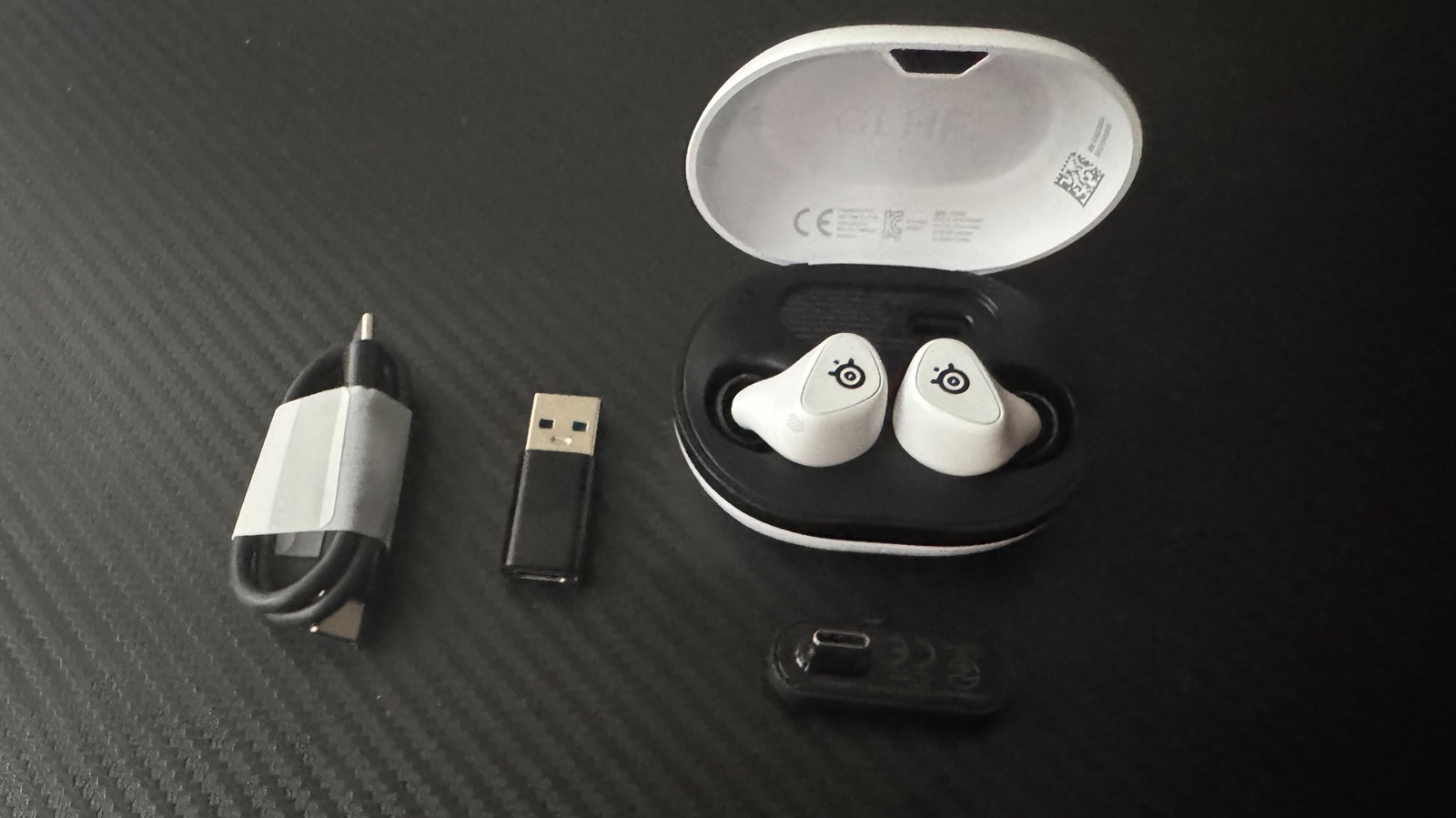 SteelSeries Arctis GameBuds with USB-C dongle, charging case, and ear tips