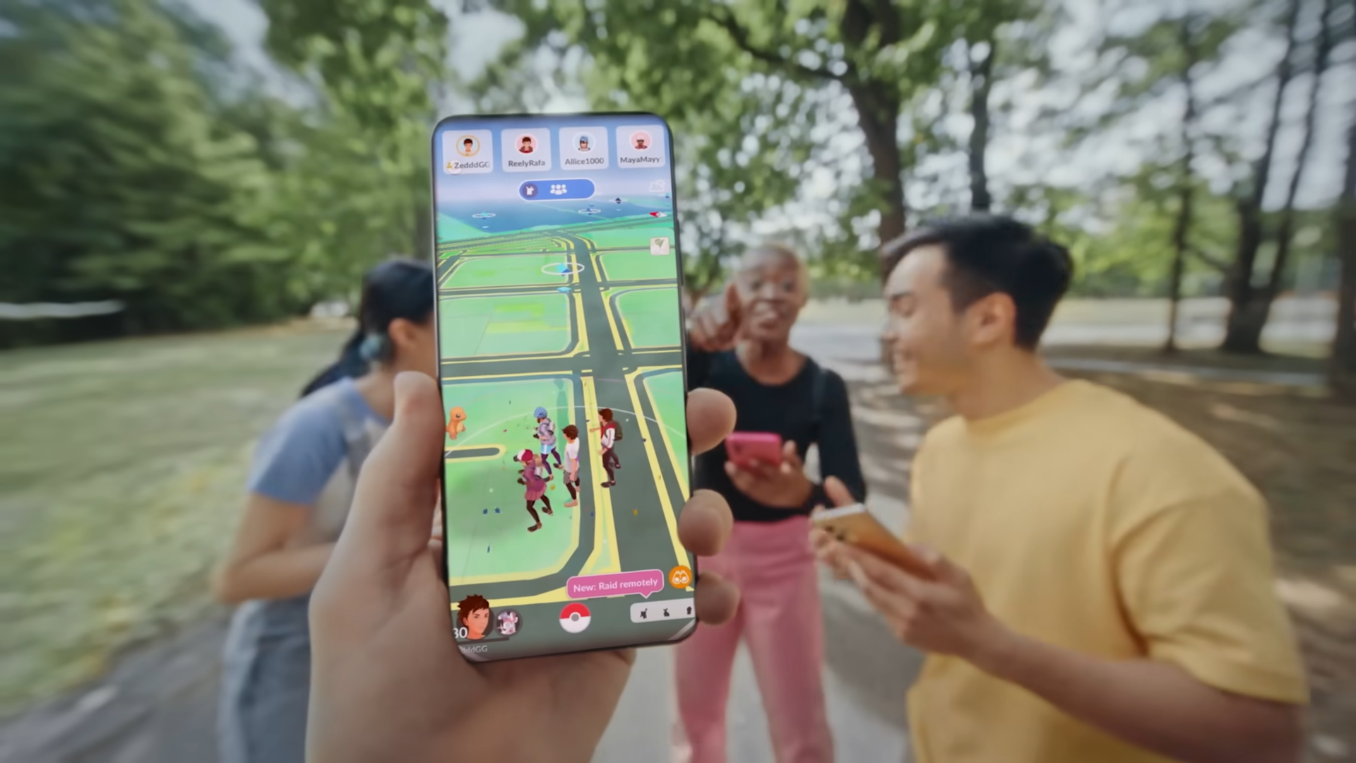 Players walking while a Pokemon GO auto catcher catches and spins in the background