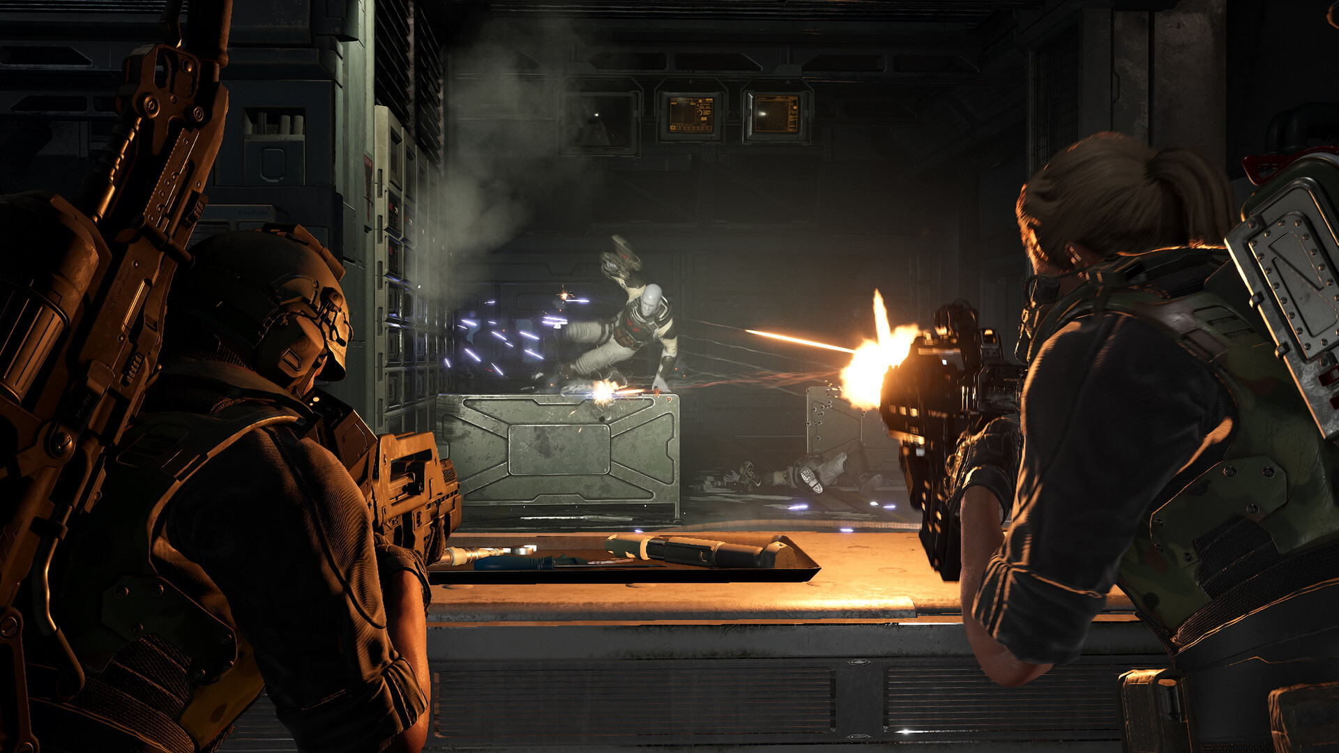 Aliens Fireteam Elite 2 marines firing down a dark corridor at a xenomorph
