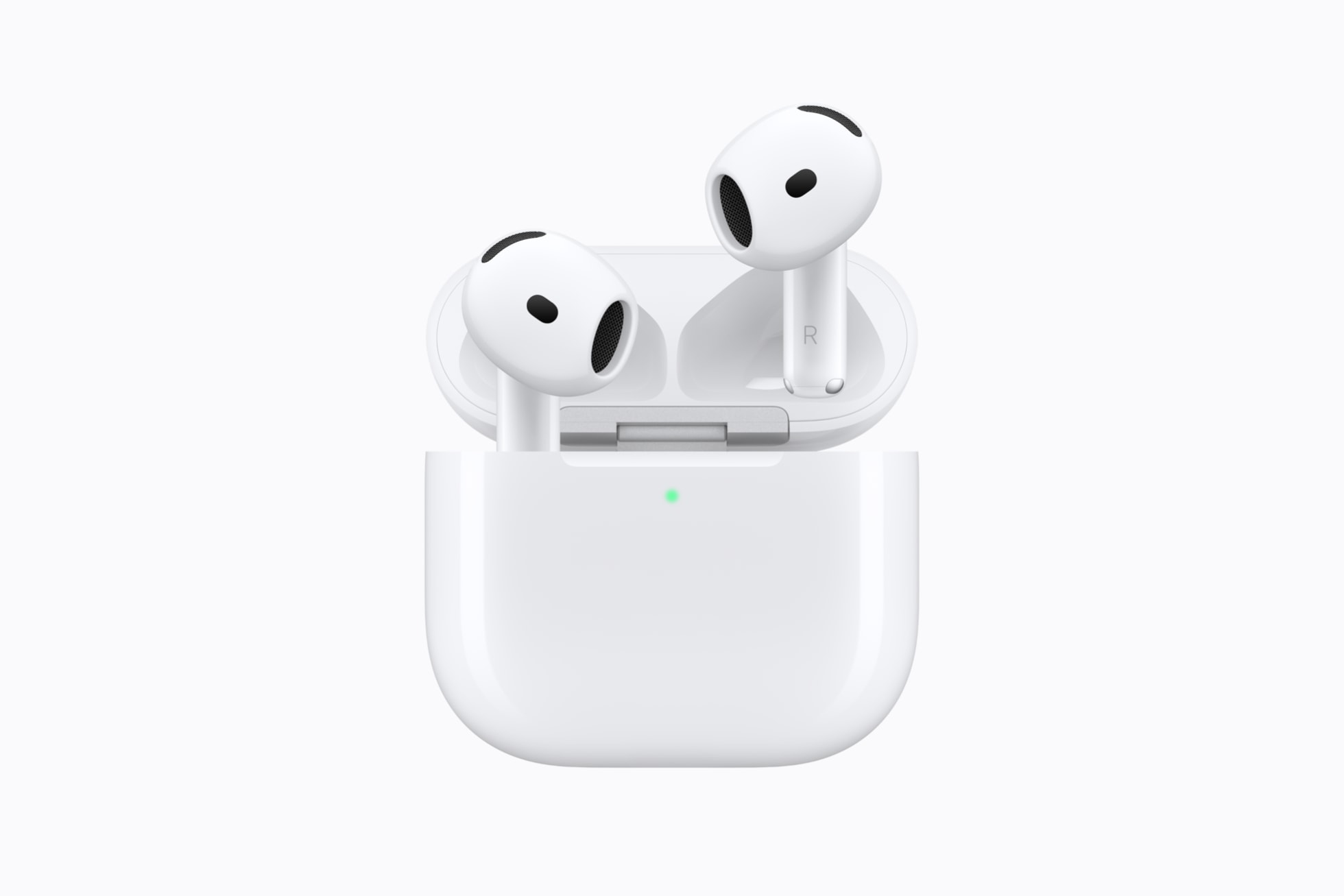 AirPods 5 earbuds beside their wireless charging case